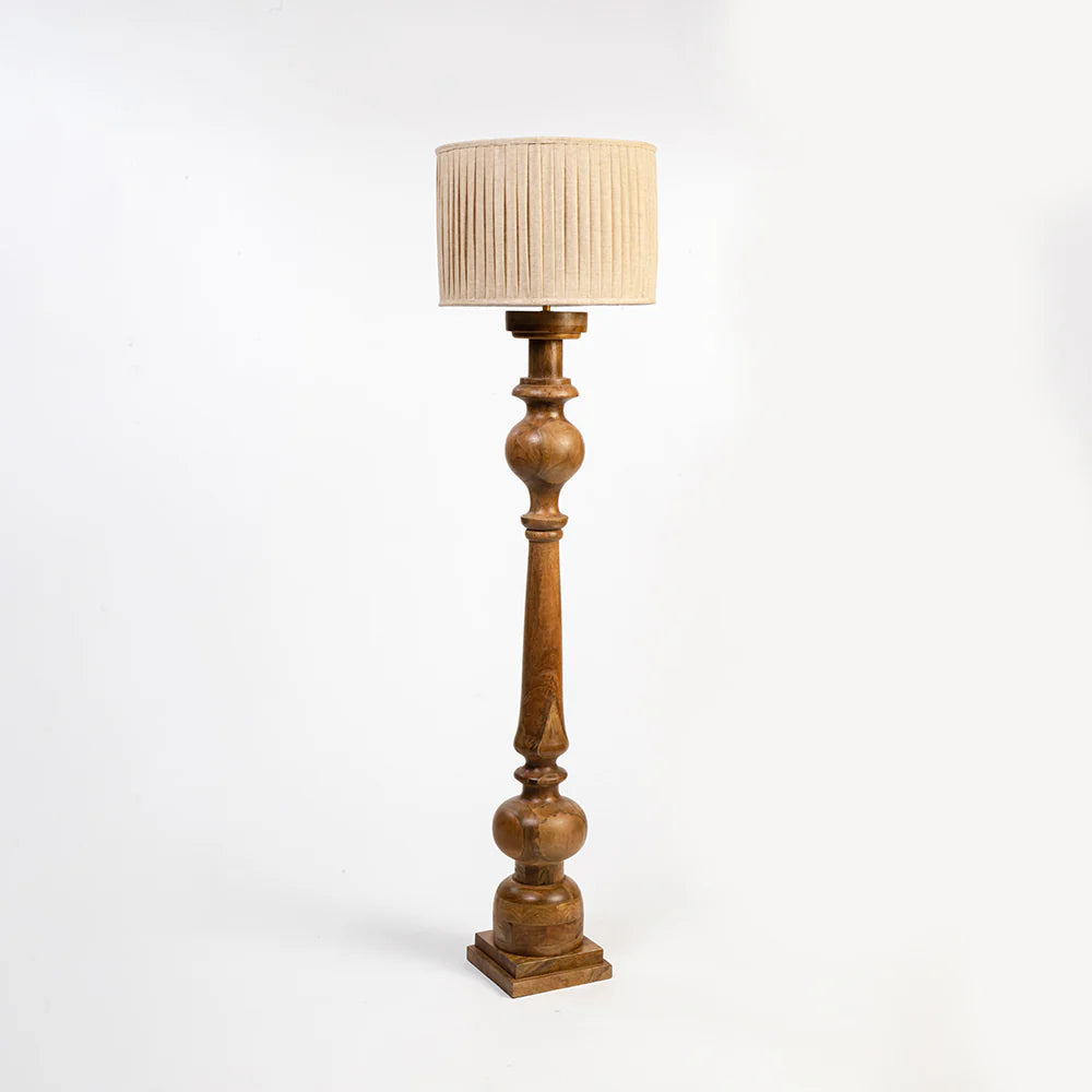 Wooden floor lamp with a beige pleated shade on a white background