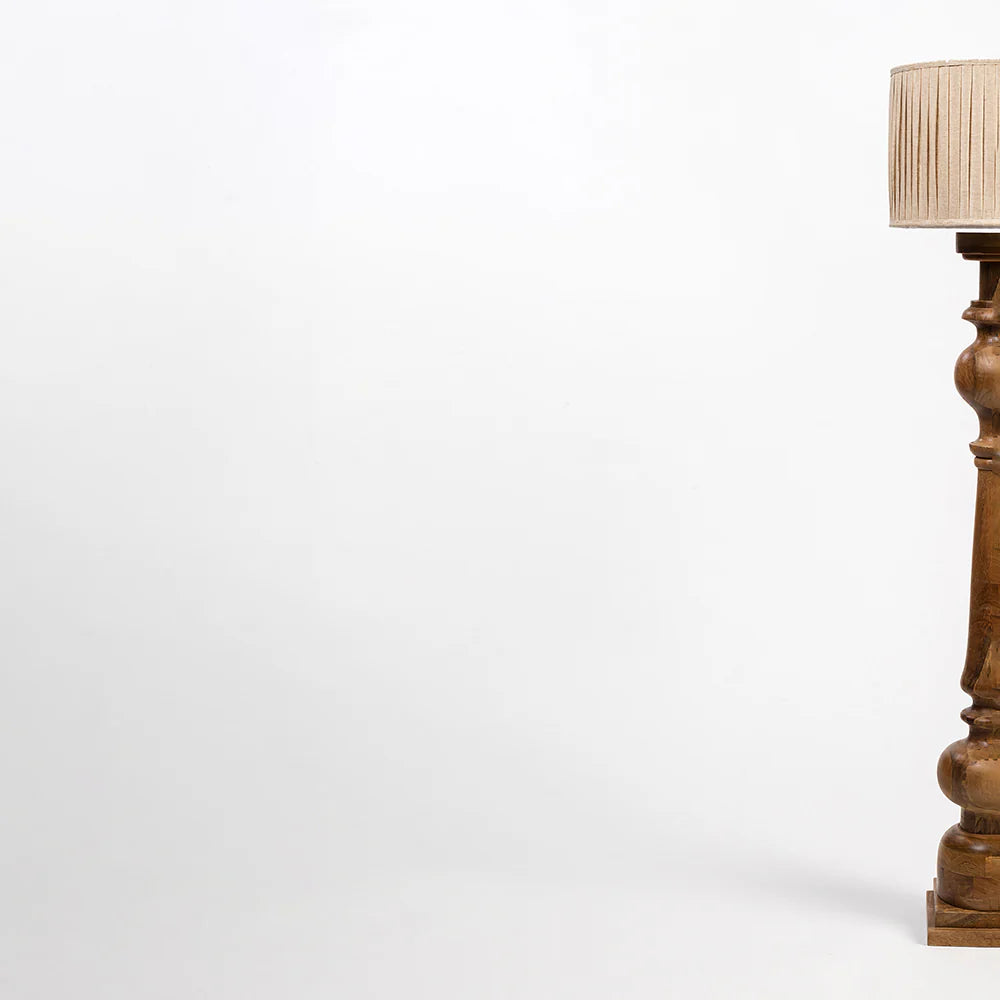 Wooden floor lamp with a beige lampshade on a white background