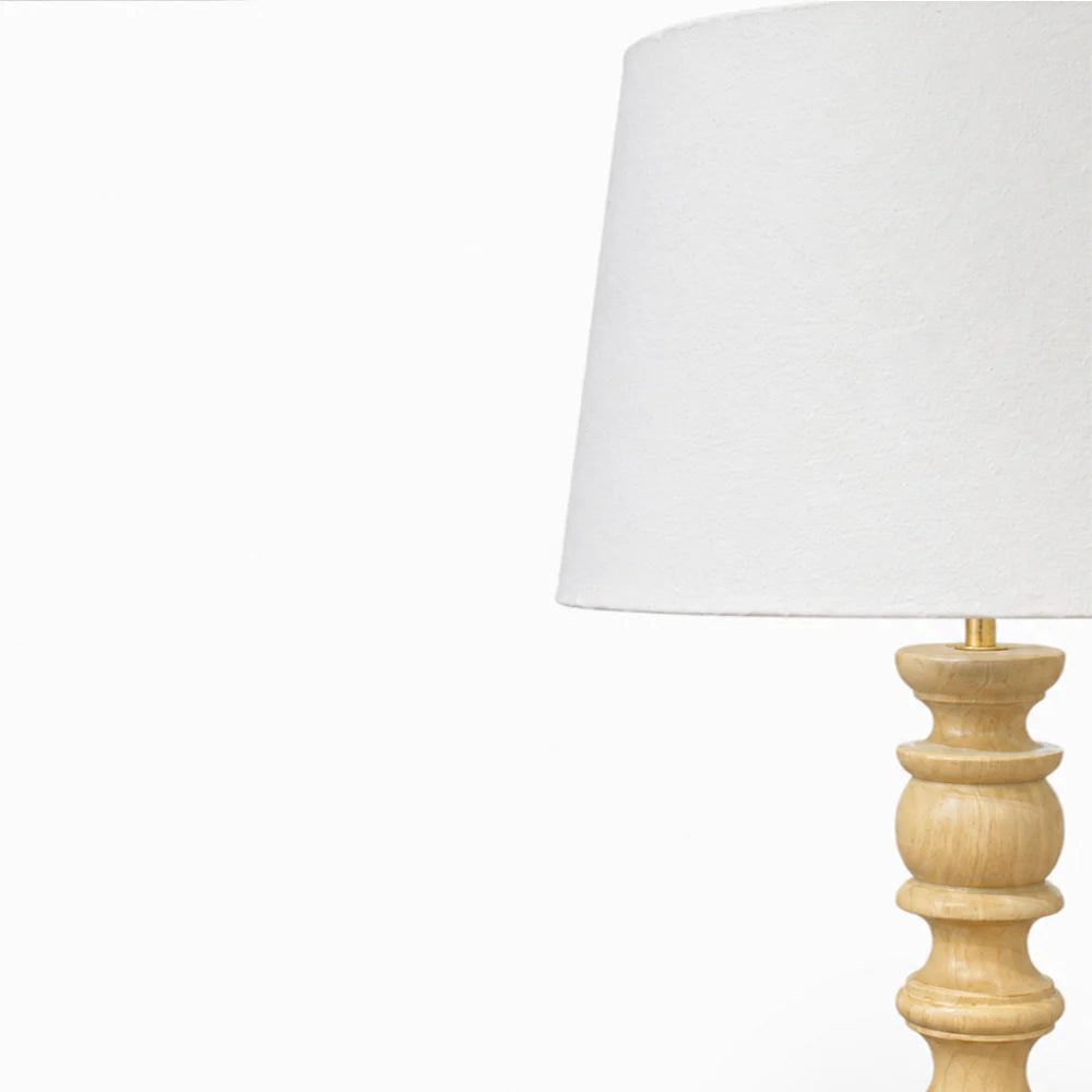 Table lamp with a white shade and wooden base on a white background