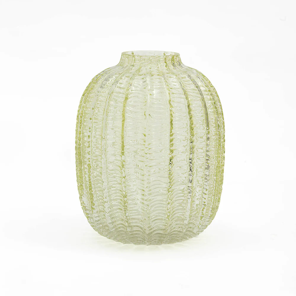 A ribbed, textured glass vase with a pale sage green tint