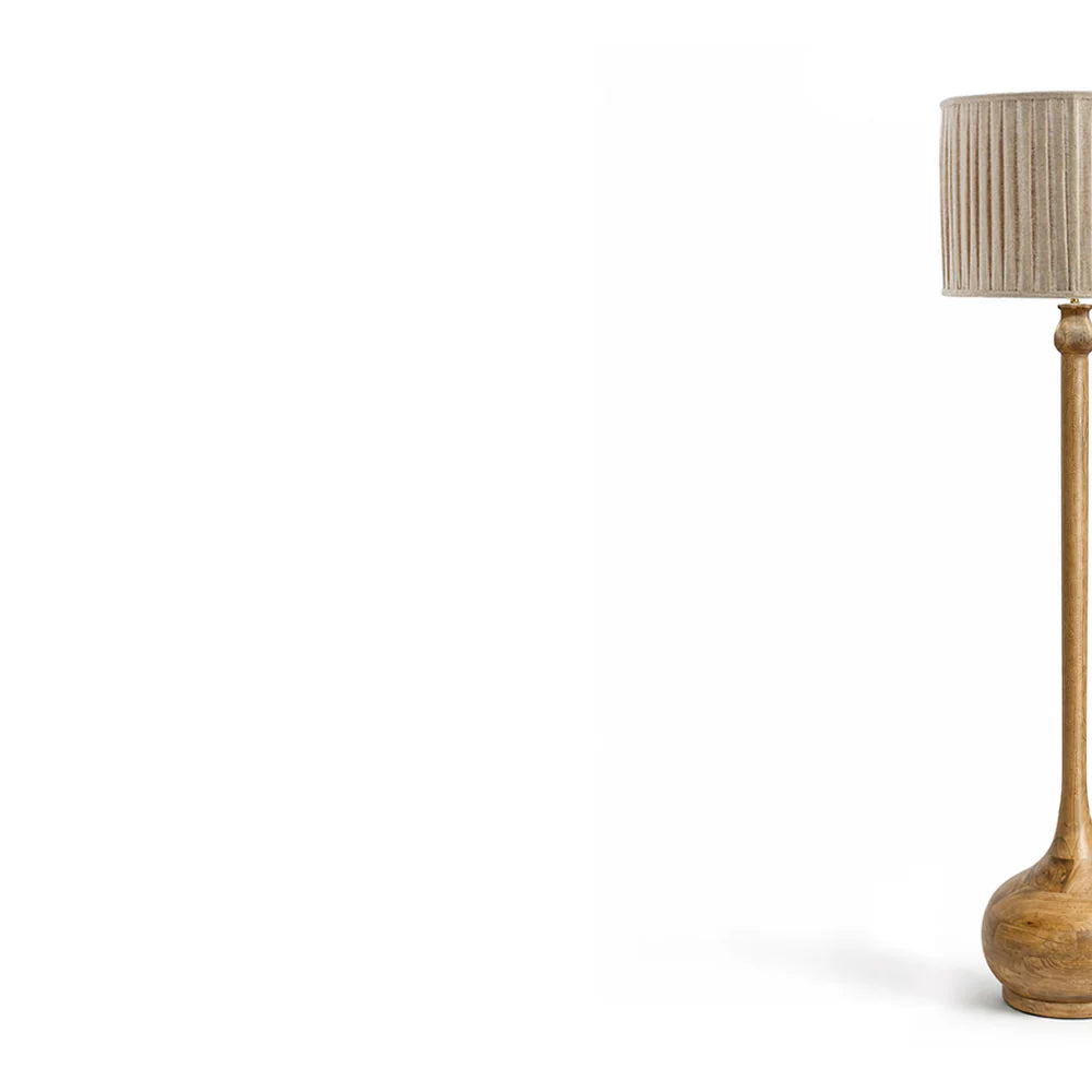Wooden floor lamp with a pleated shade on a white background